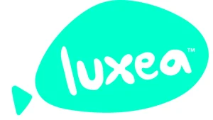 A turquoise geometric speech bubble shape with the word "luxea" in lowercase, white, rounded letters inside it. The speech bubble has a small triangular tail on the left side. A small trademark symbol (™) is in the top-right corner of the bubble, representing ACDSee Luxea Pro's video editor license.